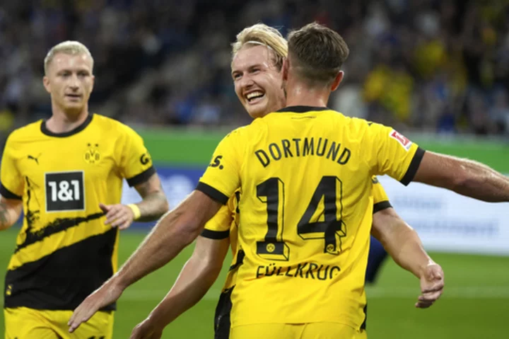 Uneven Dortmund holds on with 10 men to beat Hoffenheim 3-1 in the Bundesliga