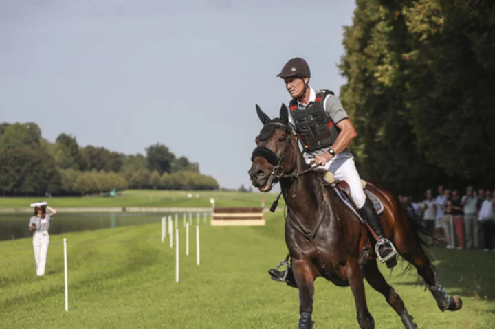 Horses gallop in Versailles Palace gardens to test the track for the Paris Olympics