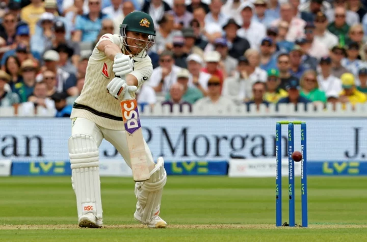 Warner shines before Australia lose Khawaja in second Test
