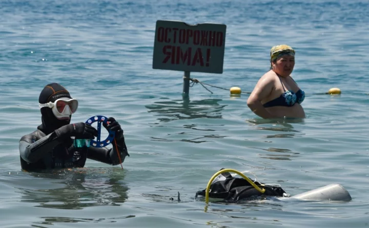 Rubbish-clearing divers come to rescue of 'pearl of Kyrgyzstan'