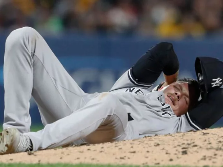 A Yankees pitcher was carted off the field and appeared bloody after being hit with a ball during a Pirates game
