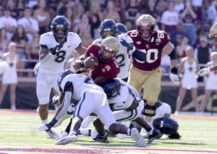 Kye Robichaux runs for 2 TDs; BC outlasts UConn 21-14 for 4th straight win