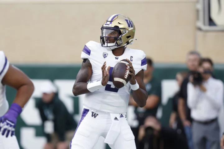 Penix leads No. 8 Washington in 41-7 rout of Michigan State, playing without suspended coach