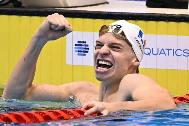 Marchand smashes Phelps's record as Titmus dominates rivals