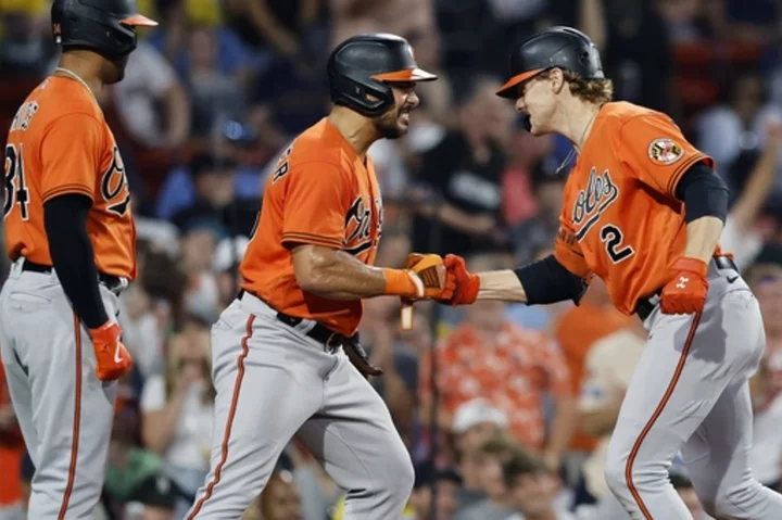 Orioles hang on to beat Red Sox 13-12 for 7th straight win as McCann homers twice