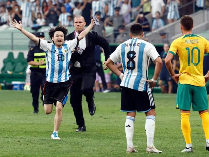 Young Chinese soccer fan gives security the slip to hug his hero Messi mid-game