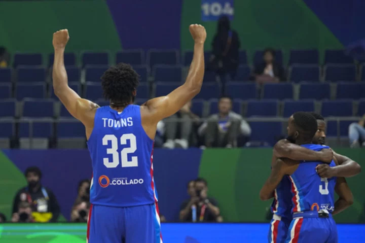 The Dominican Republic tops its World Cup group and advances with a 75-67 victory over Angola