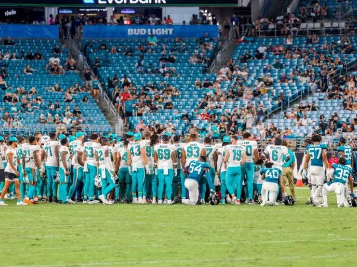 Miami Dolphins player Daewood Davis 'has movement in all extremities' after injury that led to suspension of game, team says