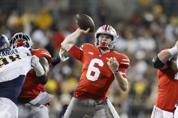 Ohio State coach Ryan Day hopes a starter emerges from QB pair, but he isn't ruling out playing both