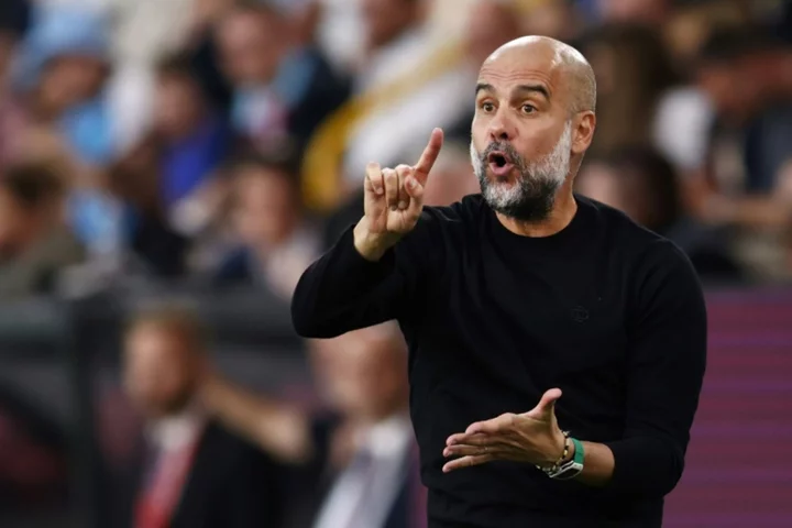 Man City manager Guardiola to miss two matches after back surgery