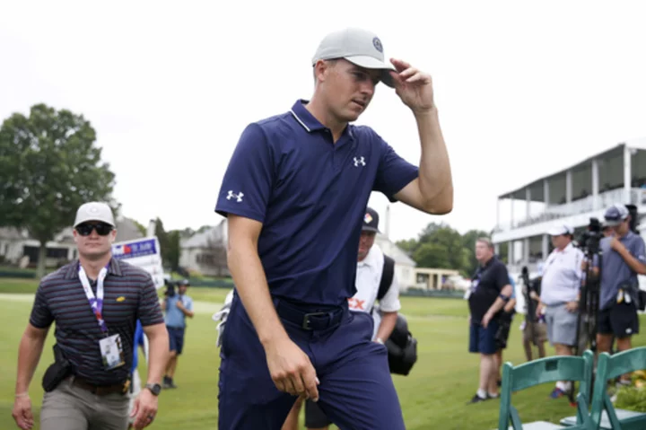 Jordan Spieth keeps a clean card in the mud for a 63 to lead the PGA Tour playoff opener