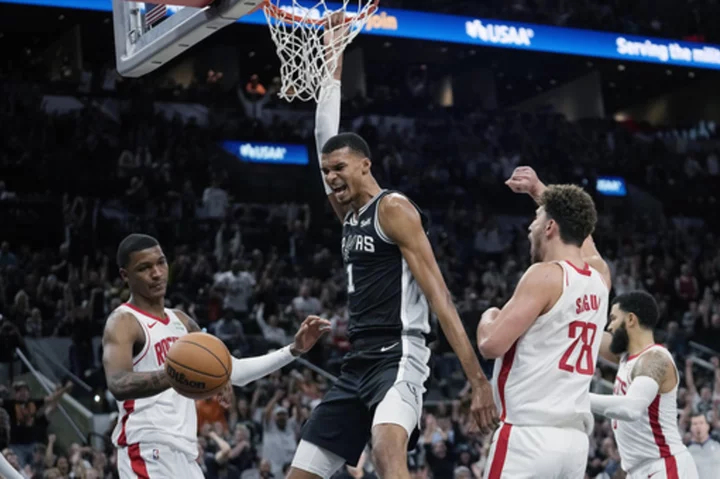 Wembanyama makes tying basket in regulation, then earns his first NBA win as Spurs top Rockets in OT