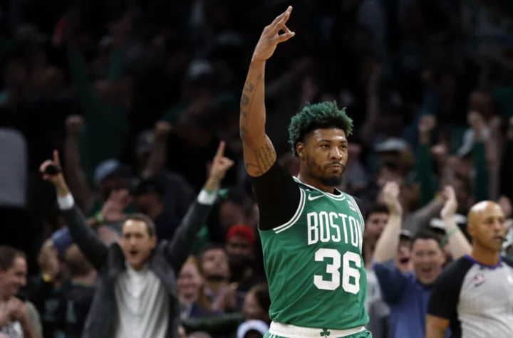 Why does Marcus Smart dye his hair green?