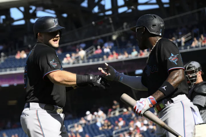 Cueto wins in his return as Burger hits 2 of the Marlins' 4 home runs in win over the Nationals