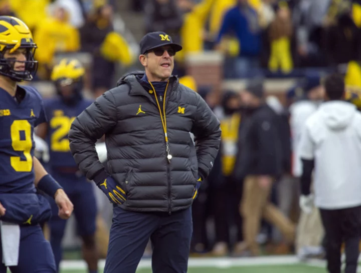 Michigan's Jim Harbaugh says he would take less salary if it meant college athletes would be paid