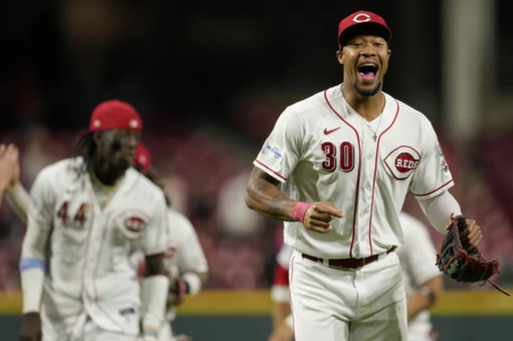 Phillips gets first major league win and Benson had 3 RBIs to lead Reds over Twins 7-3