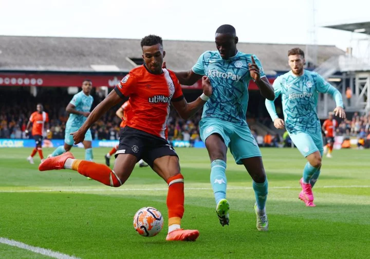 Soccer-Luton earn first Premier League point with draw against 10-man Wolves