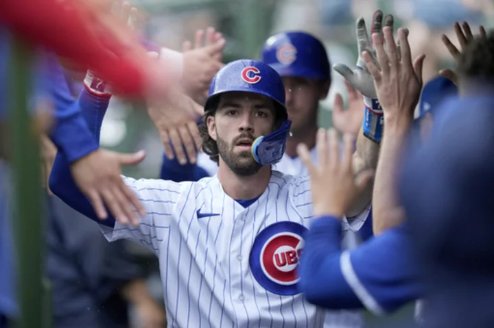 Swanson and Candelario go deep as the Cubs hold off the Braves 8-6 at rainy Wrigley