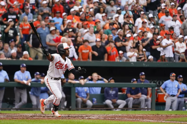 Mullins' 11th-inning sacrifice fly lifts Orioles over Rays after both teams clinch postseason spots