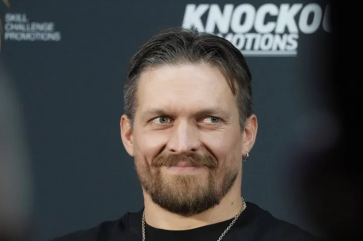 Usyk weighs in lighter than Dubois for title fight. Ukrainian says his heart makes up the difference