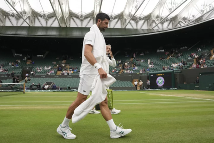 Novak Djokovic and Carlos Alcaraz warm up on No. 1 Court for their Wimbledon semifinal matches
